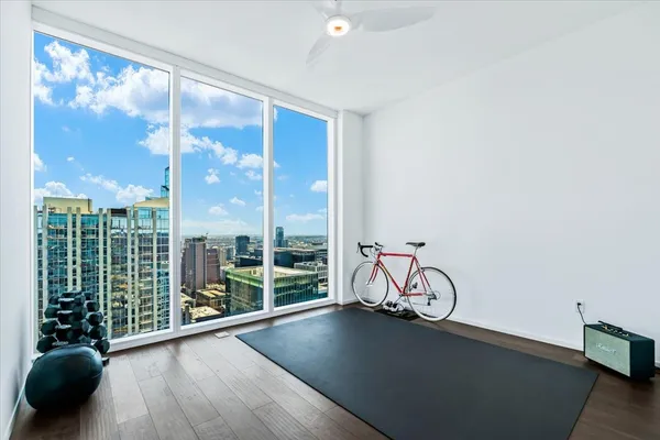 a view of a livingroom with furniture and floor to ceiling window