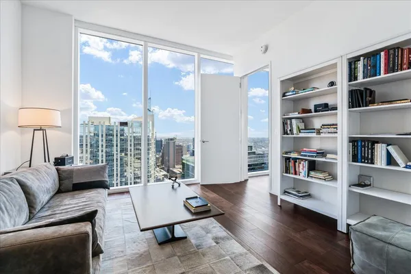 a living room with furniture and a book shelf