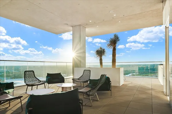 a balcony with chairs and table
