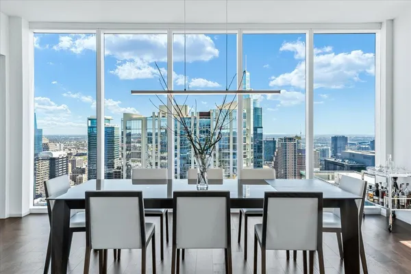 a kitchen with a large window and dining table