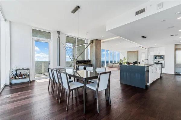 a view of a dining room with furniture and wooden floor