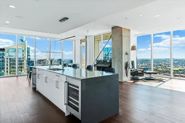 a kitchen with stainless steel appliances granite countertop a stove and a wooden floors