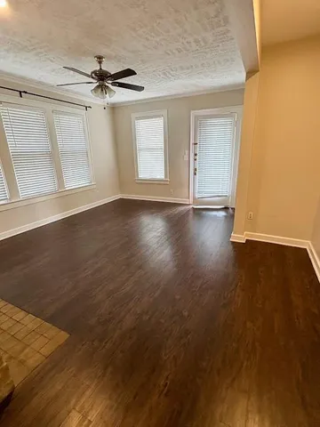 a view of a livingroom with wooden floor and window