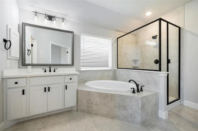 a bedroom with a bed and a white cabinet