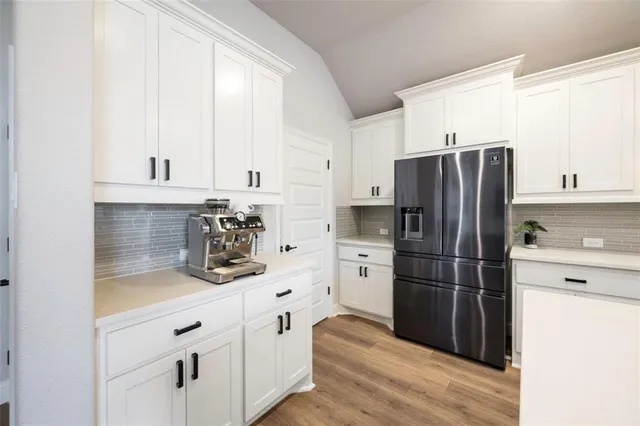 a kitchen with stainless steel appliances a stove microwave and sink