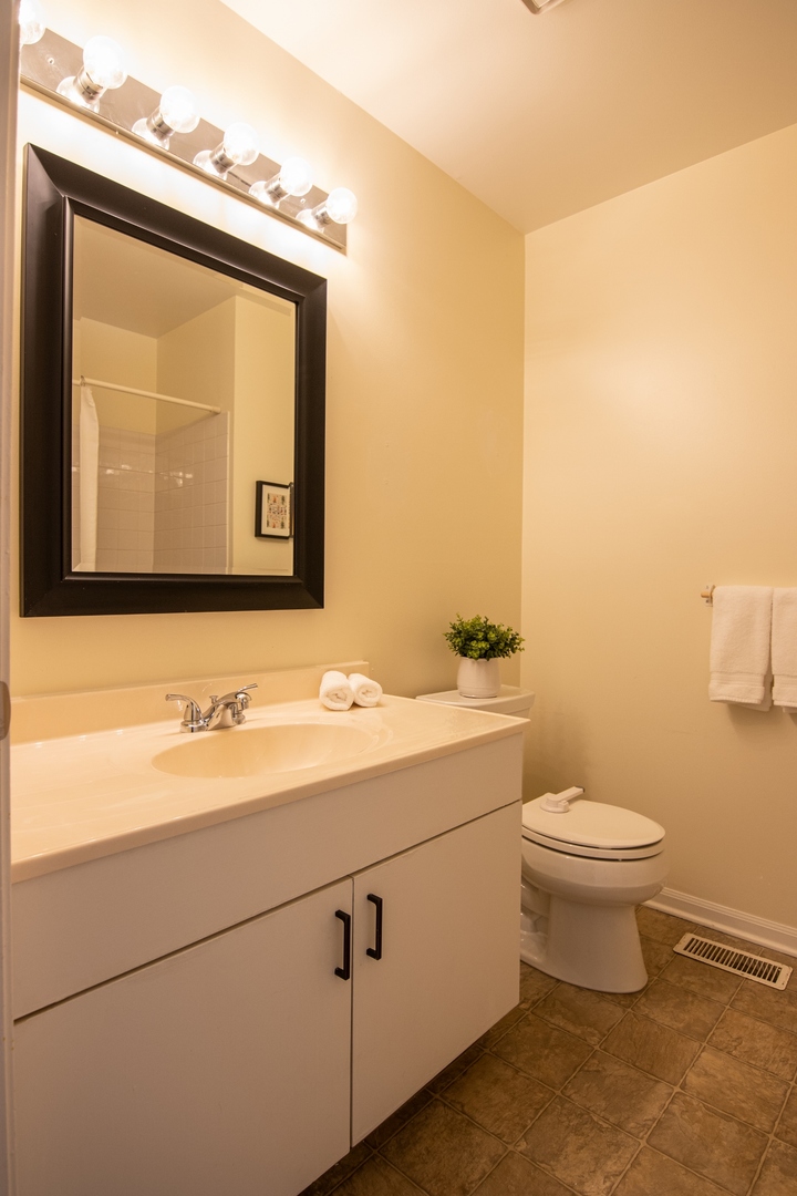 1213 Koster Court Geneva, IL 60134 - Photo 16 of 30 a bathroom with a toilet sink and mirror