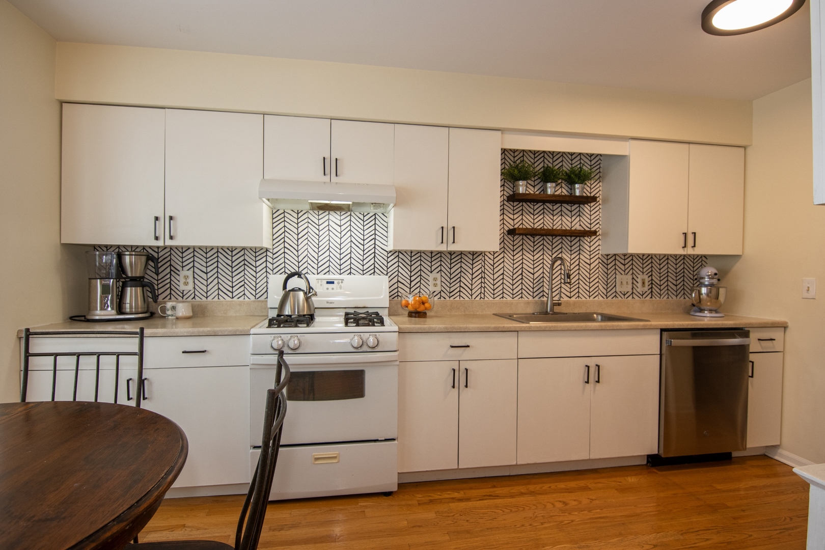 1213 Koster Court Geneva, IL 60134 - Photo 6 of 30 a kitchen with a sink cabinets and wooden floor