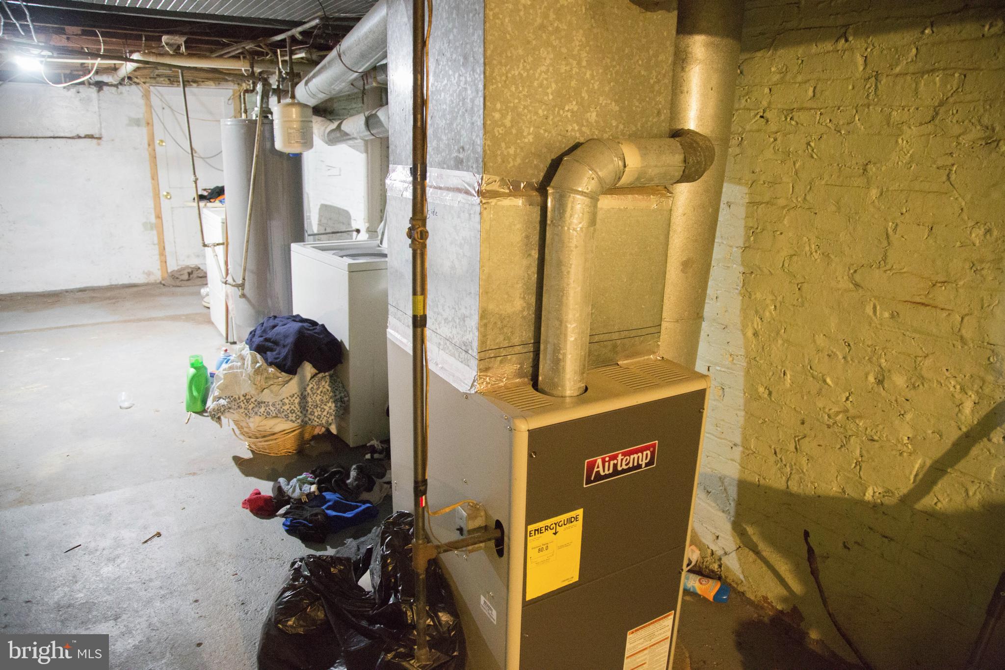1708 Normal Avenue Baltimore, MD 21213 - Photo 13 of 18 a bathroom with a mirror and a shower