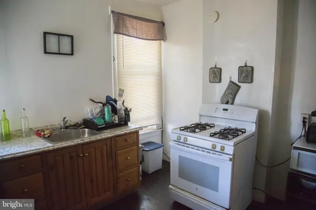 a kitchen with stainless steel appliances granite countertop a sink stove and cabinets