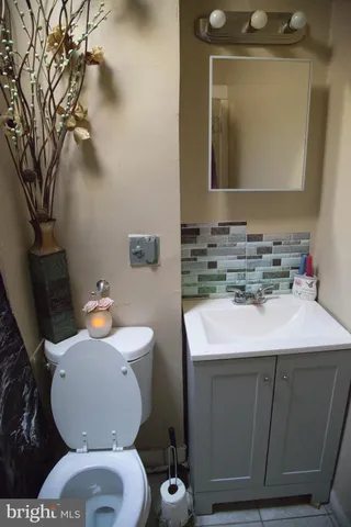 a bathroom with a sink toilet and mirror