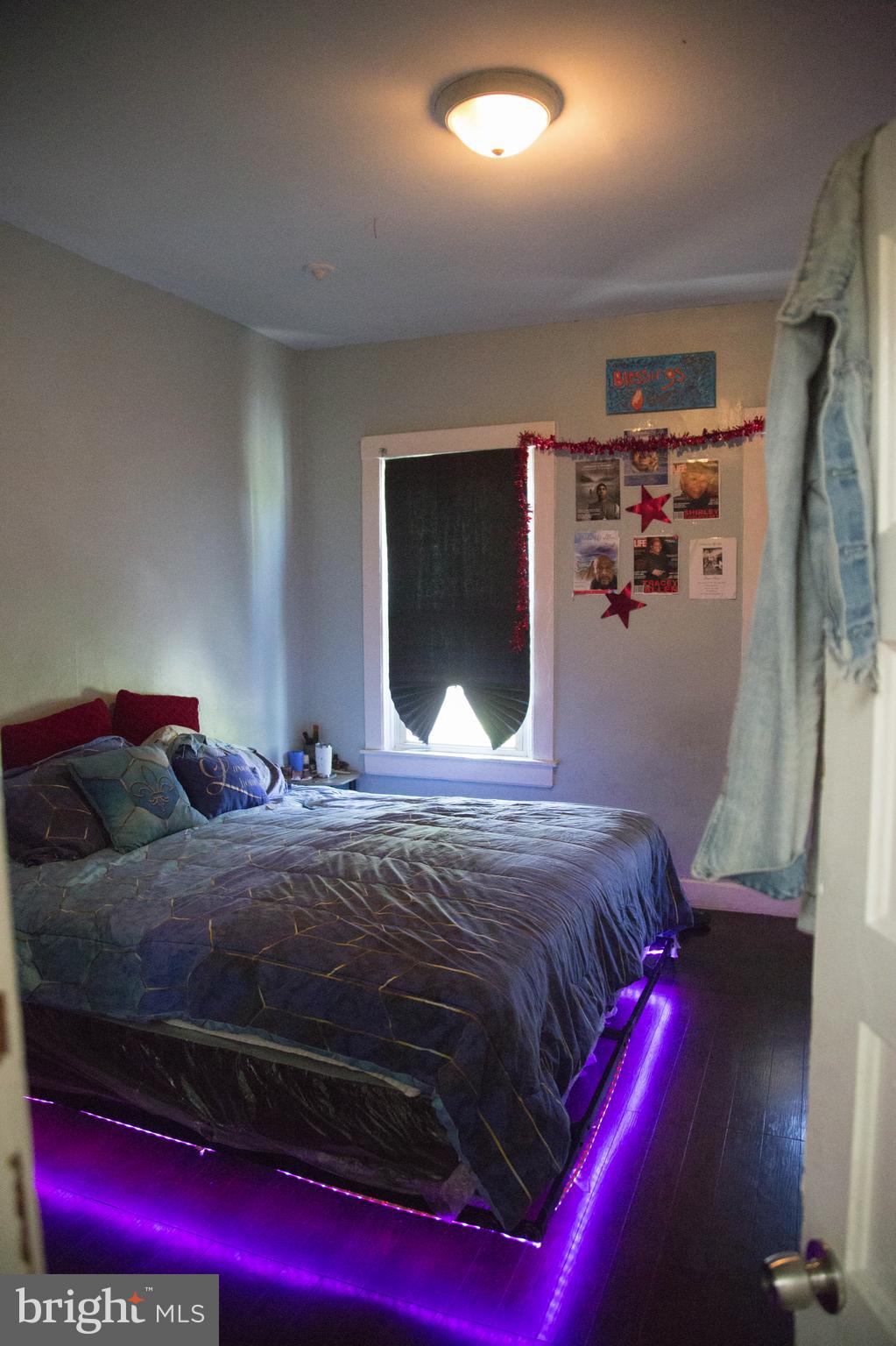 1708 Normal Avenue Baltimore, MD 21213 - Photo 9 of 18 a bedroom with a bed and a flat screen tv