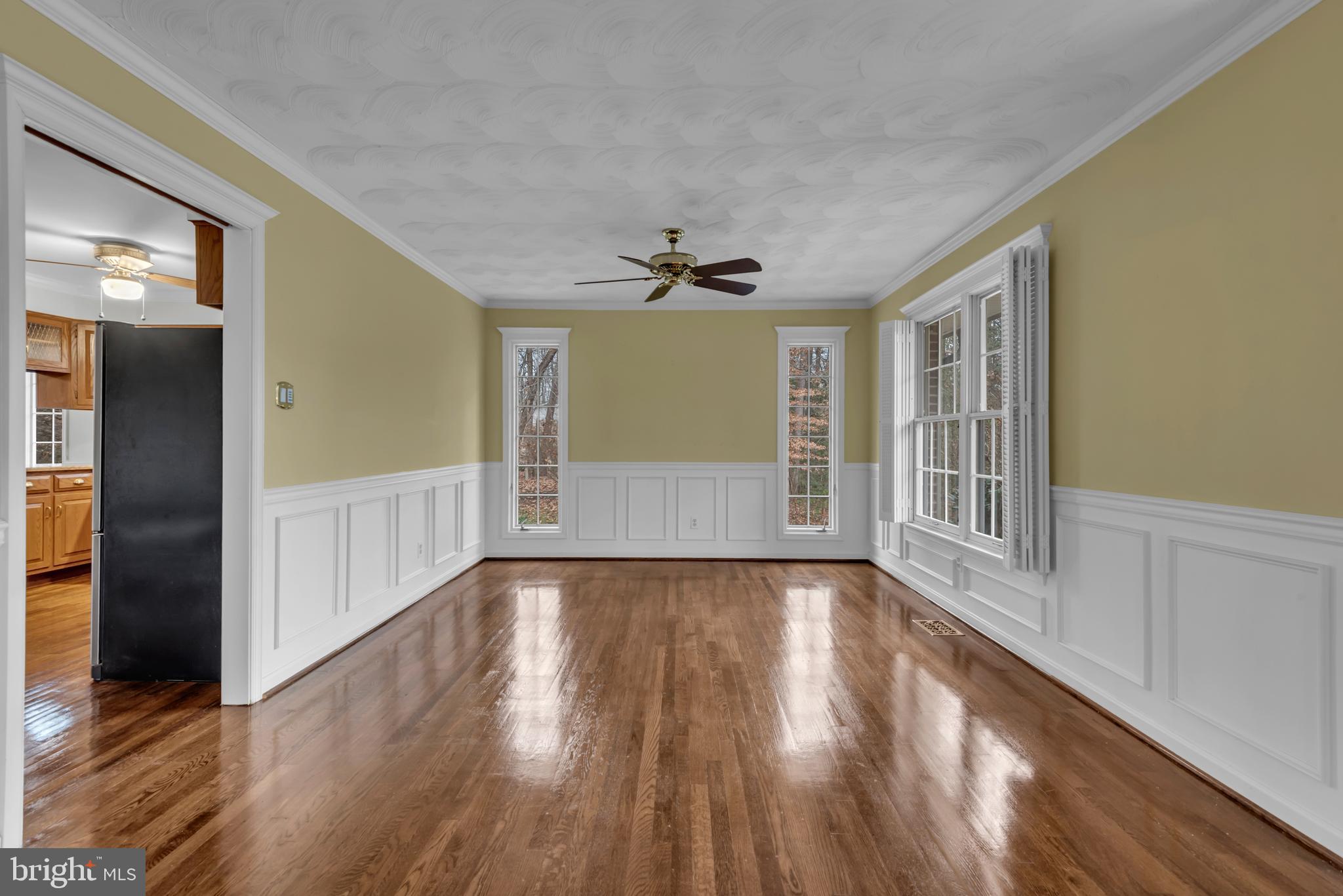 671 Discovery Court Davidsonville, MD 21035 - Photo 13 of 71 a view of an empty room with a window and wooden floor