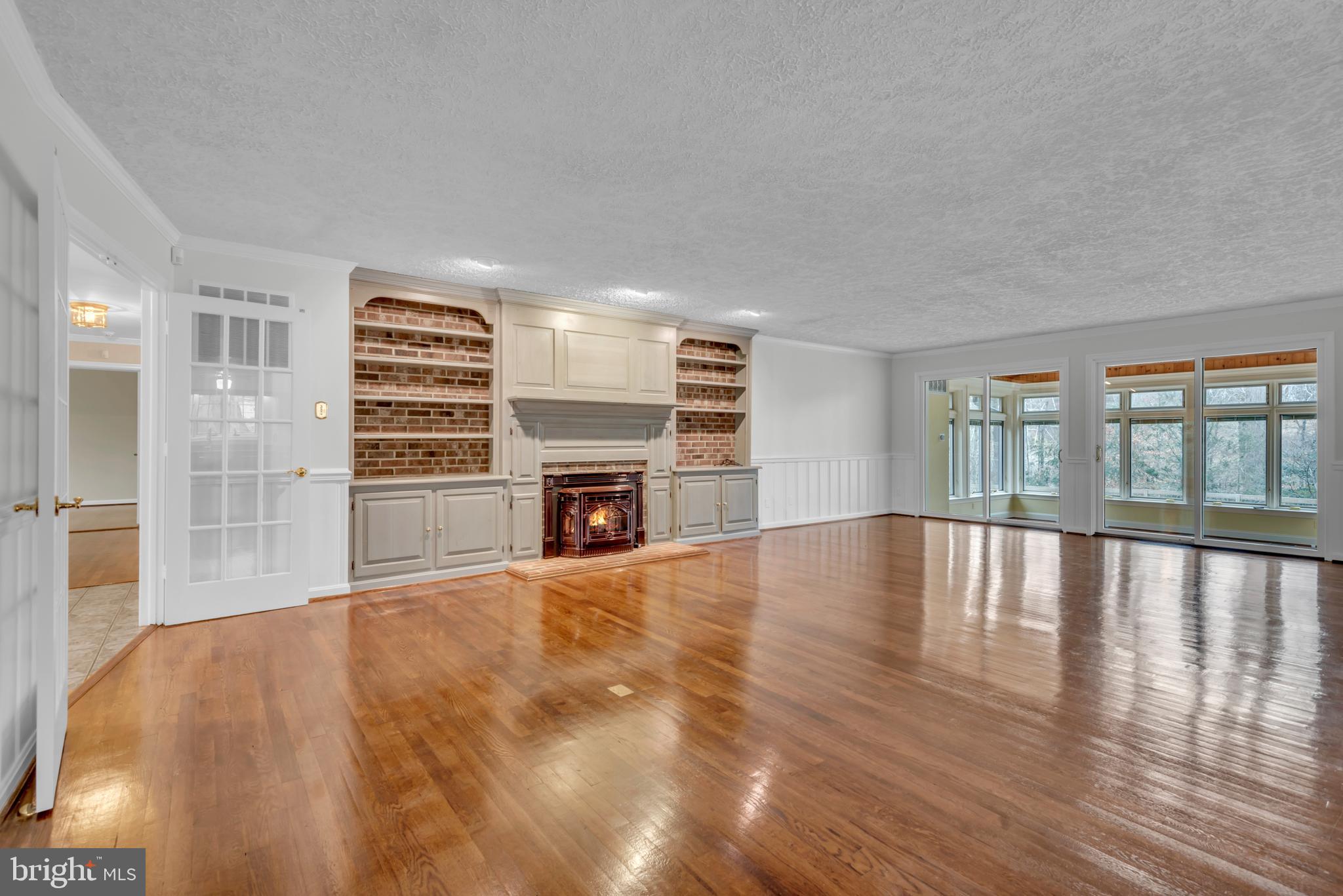 671 Discovery Court Davidsonville, MD 21035 - Photo 16 of 71 a view of empty room with wooden floor and fireplace