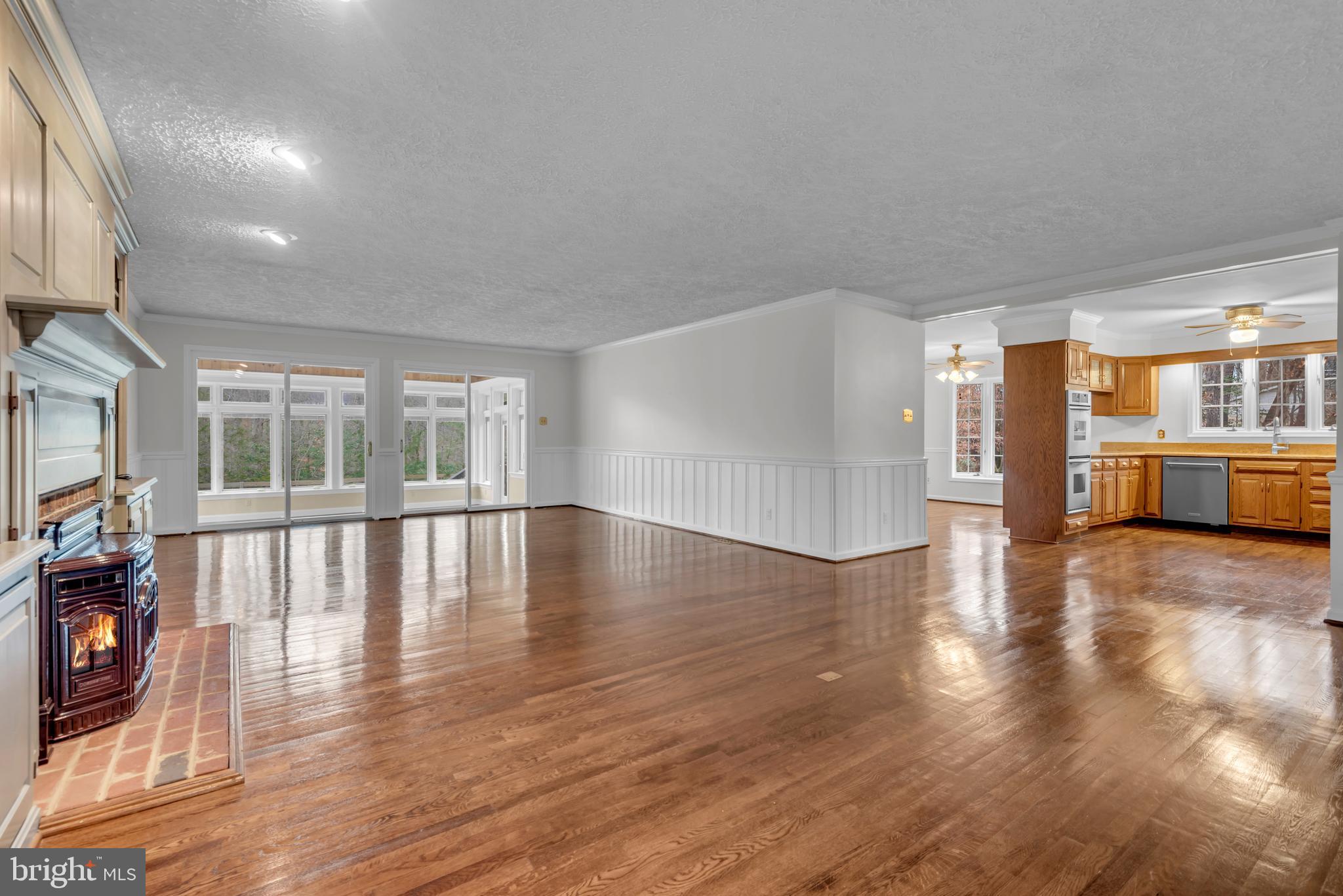 671 Discovery Court Davidsonville, MD 21035 - Photo 20 of 71 a view of empty room with wooden floor and fireplace