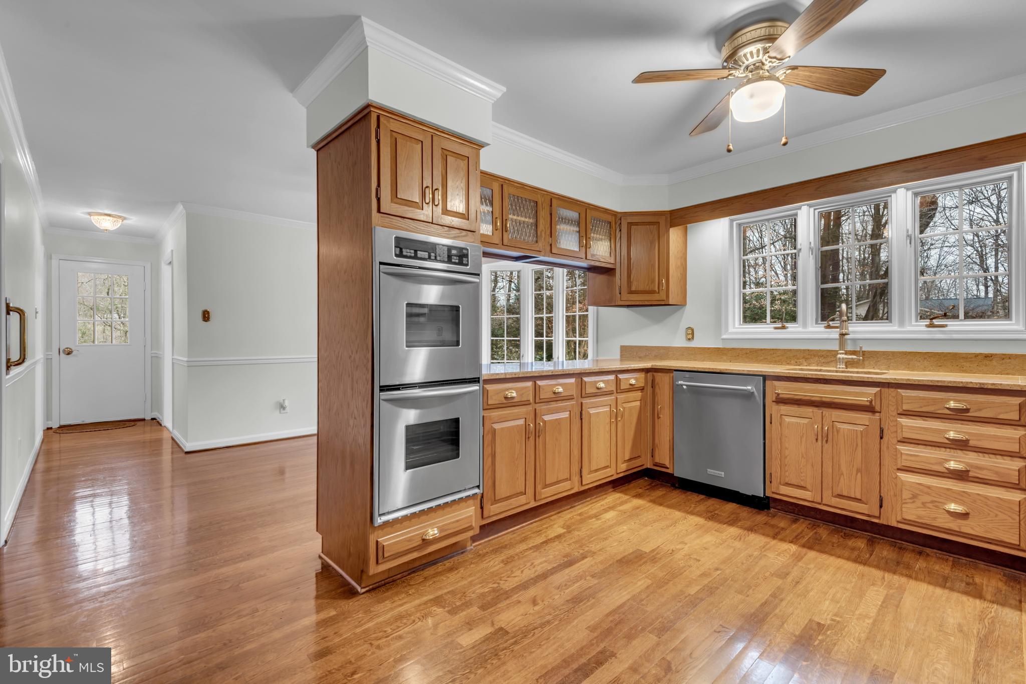 671 Discovery Court Davidsonville, MD 21035 - Photo 34 of 71 a kitchen with granite countertop a stove a sink a refrigerator and wooden floor