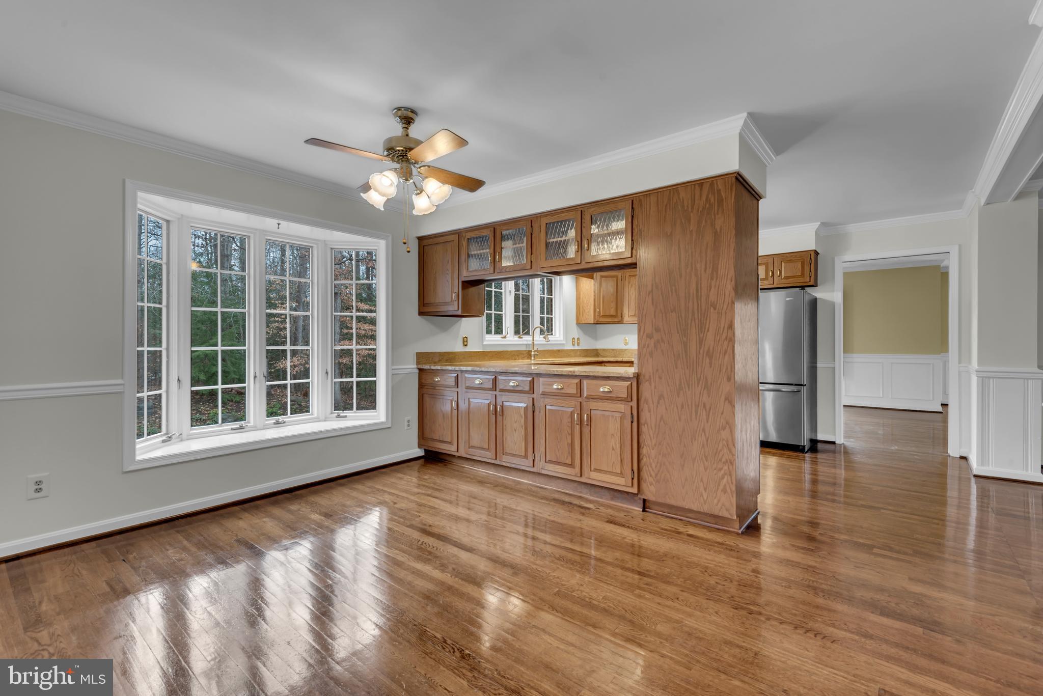 671 Discovery Court Davidsonville, MD 21035 - Photo 36 of 71 a view of a kitchen with wooden cabinet and a large window