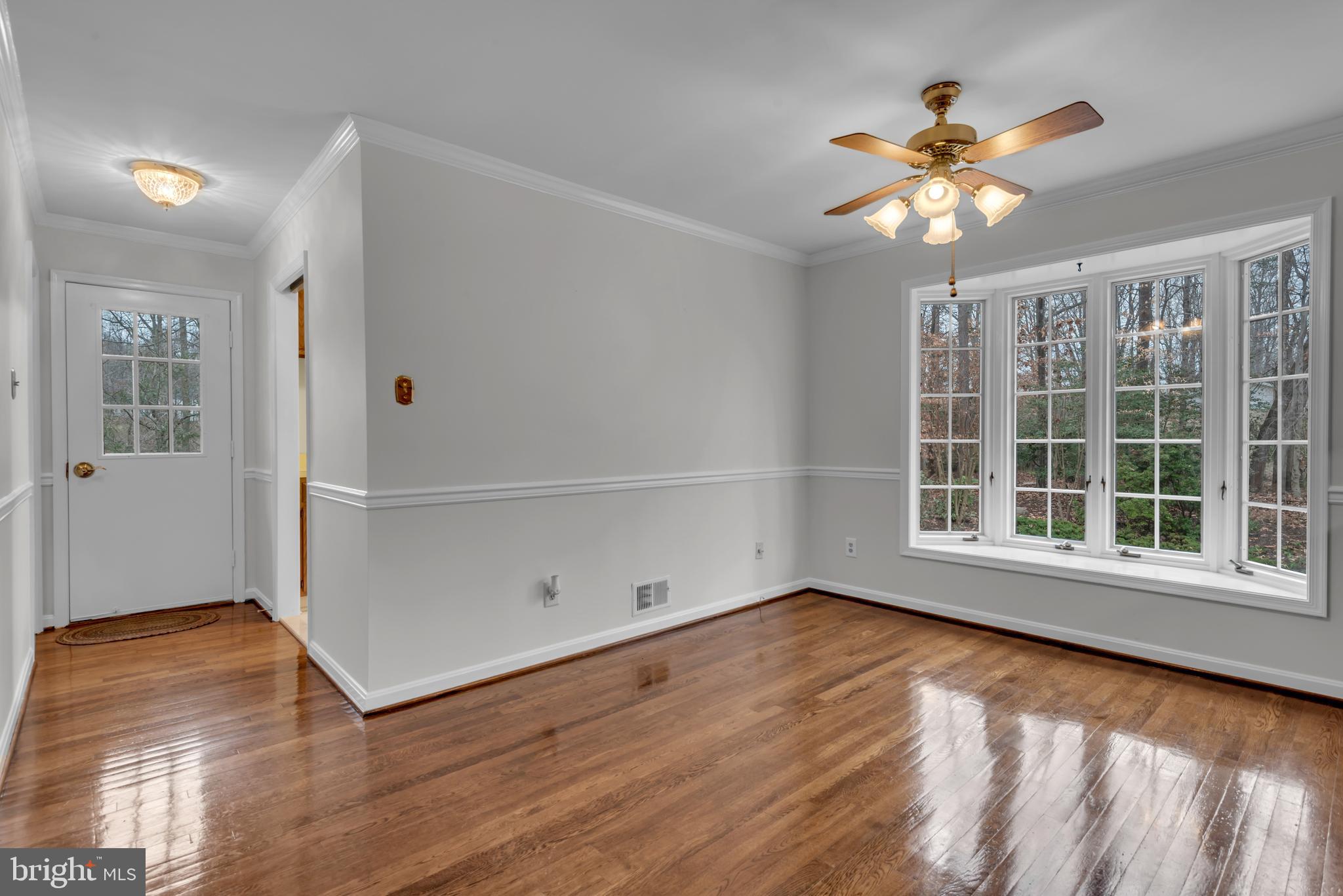 671 Discovery Court Davidsonville, MD 21035 - Photo 37 of 71 a view of an empty room with wooden floor and a window