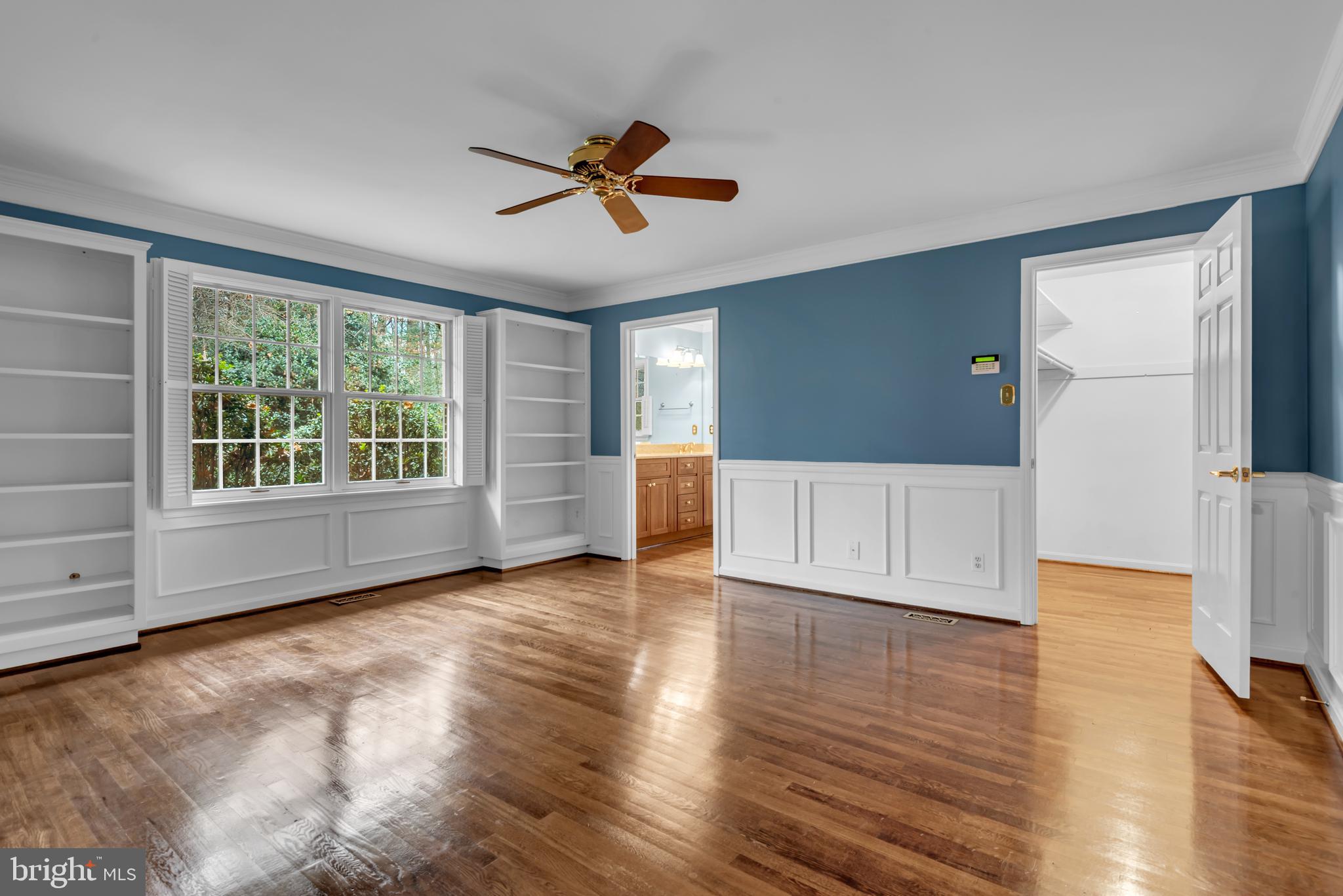 671 Discovery Court Davidsonville, MD 21035 - Photo 42 of 71 a view of an empty room with a window and wooden floor