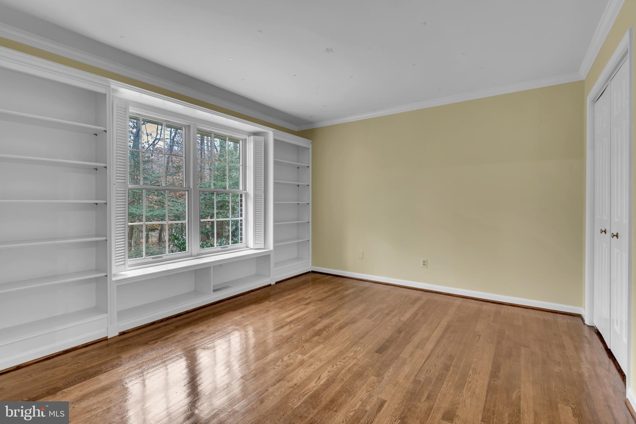 671 Discovery Court Davidsonville, MD 21035 - Photo 49 of 71 a view of an empty room with wooden floor and a window