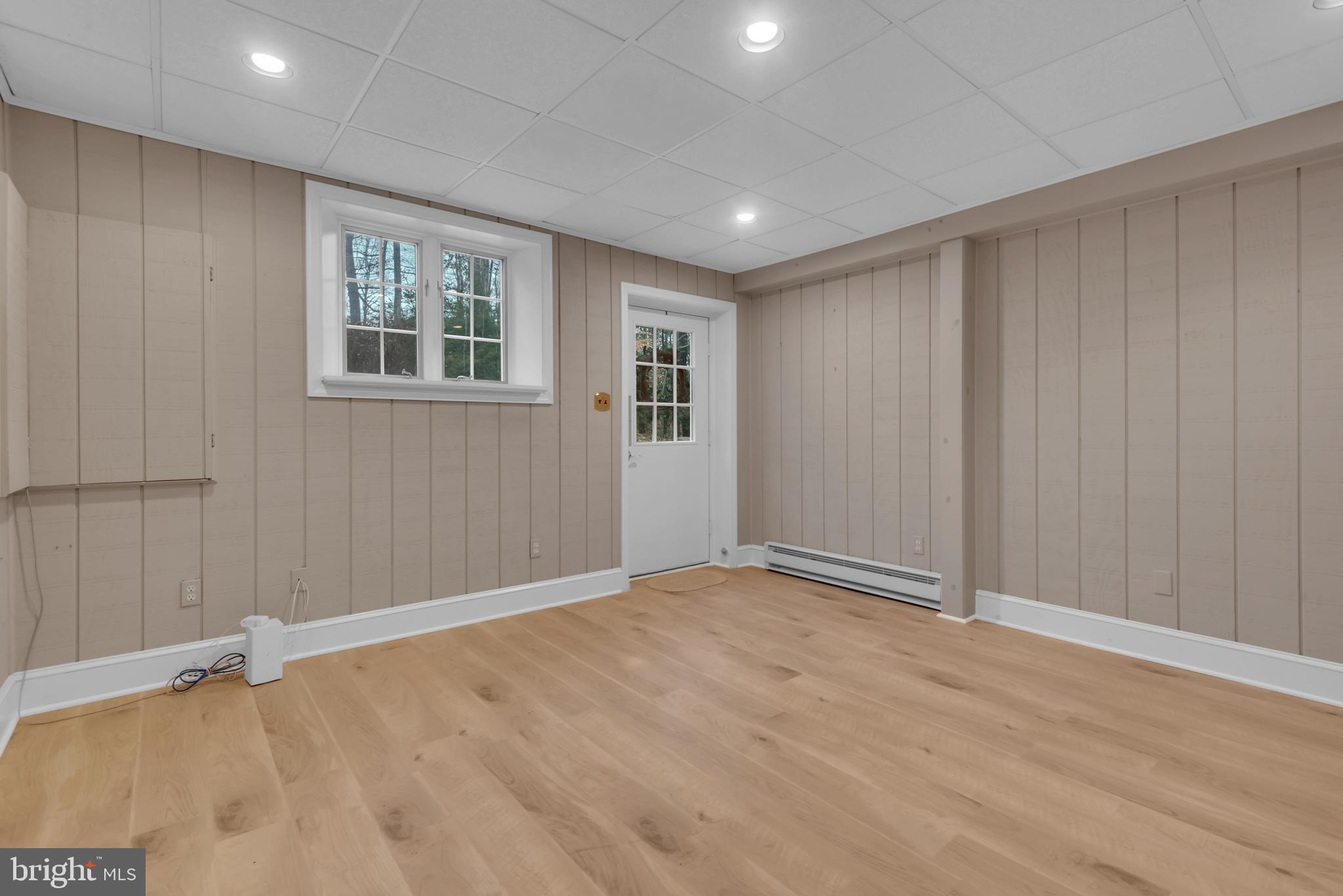 671 Discovery Court Davidsonville, MD 21035 - Photo 55 of 71 a view of an empty room with wooden floor and a window