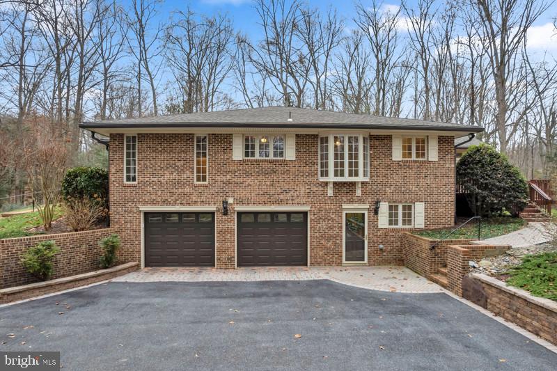 671 Discovery Court Davidsonville, MD 21035 - Photo 7 of 71 a front view of a house with a yard and garage