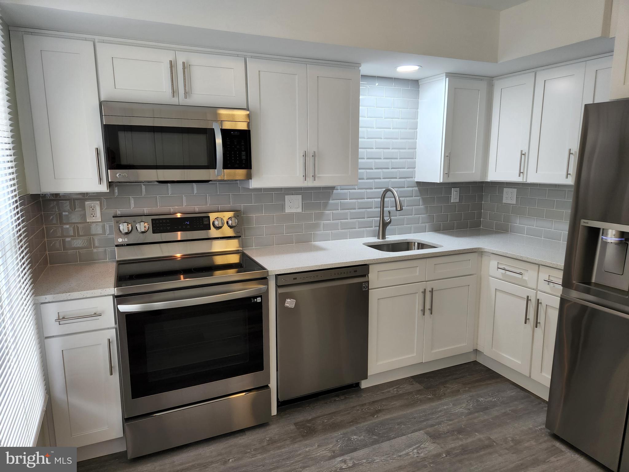 29 Providence Avenue Doylestown, PA 18901 - Photo 2 of 12 a kitchen with white cabinets stainless steel appliances and sink