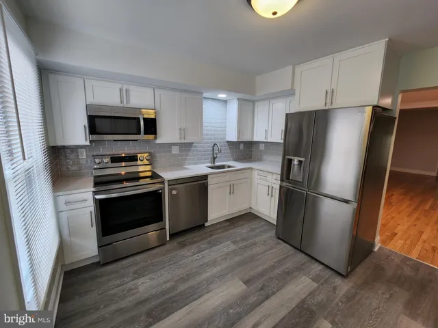 a kitchen with a refrigerator stove and a sink