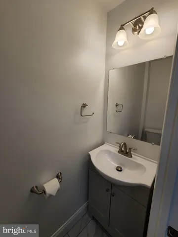 a bathroom with a sink a mirror and vanity