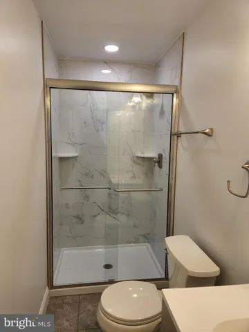 a bathroom with a toilet and a shower