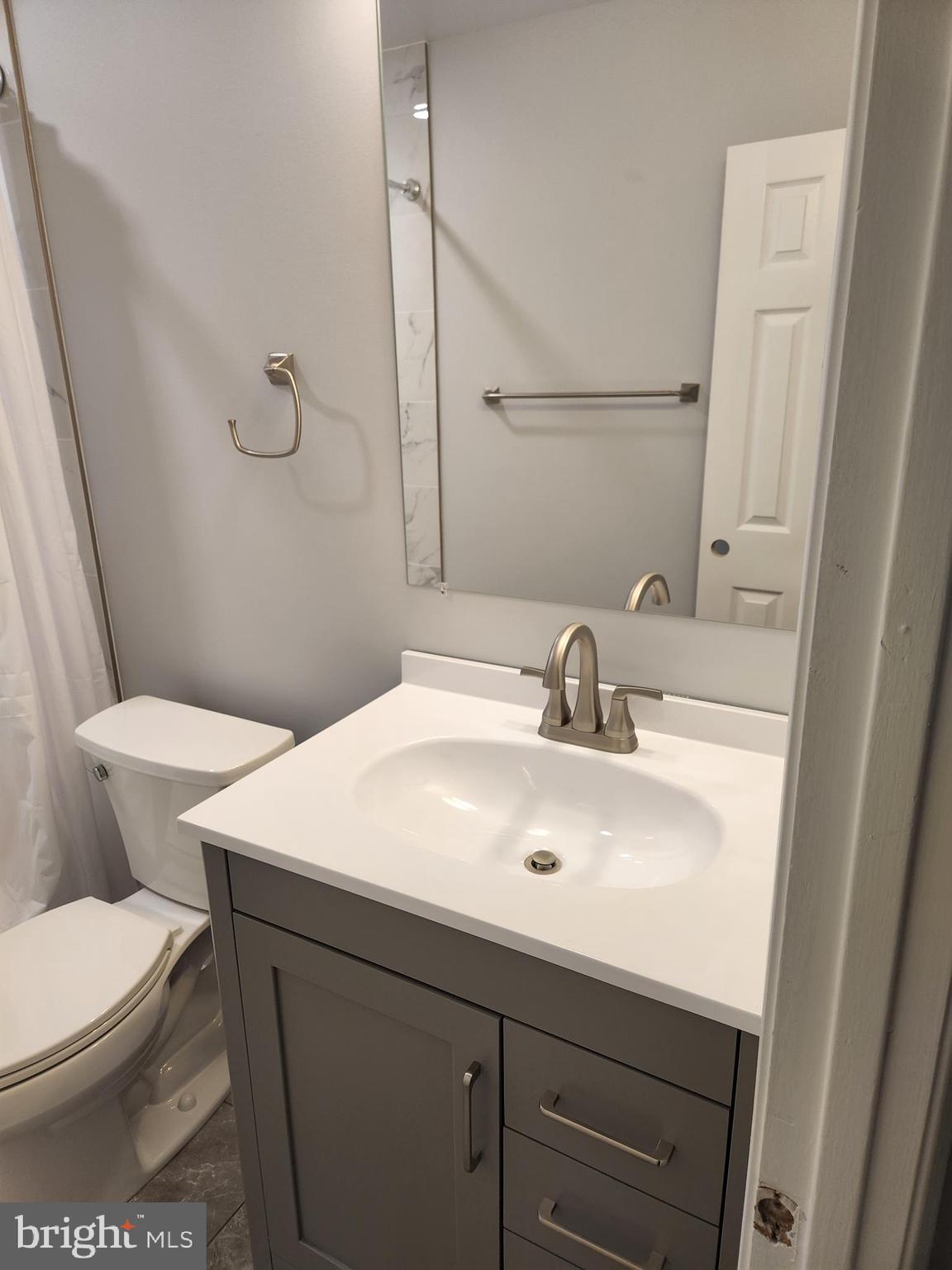 29 Providence Avenue Doylestown, PA 18901 - Photo 10 of 12 a bathroom with a sink a toilet a mirror and vanity