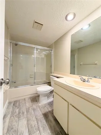 a bathroom with a sink a toilet and a large mirror