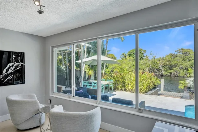 a living room with couch and a large window