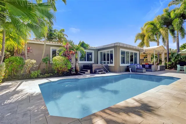 a view of a house with swimming pool and sitting area