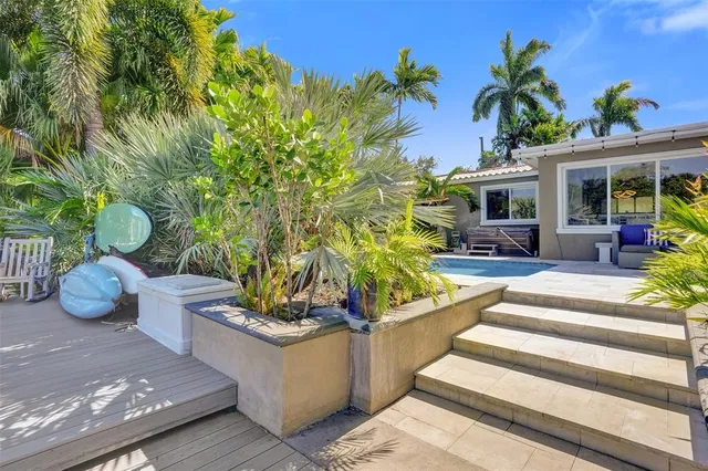 a view of a house with sitting area and garden