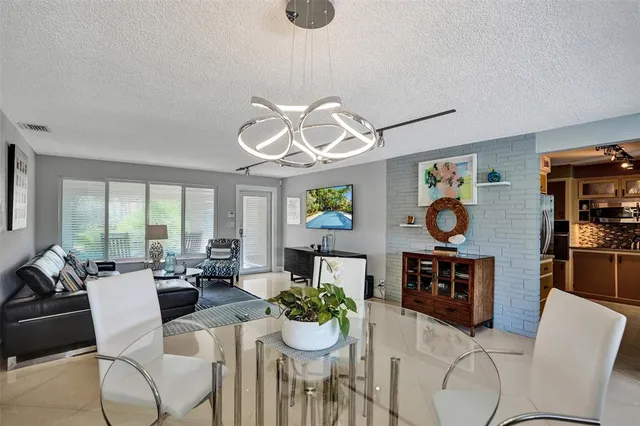 a living room with furniture chandelier and a window