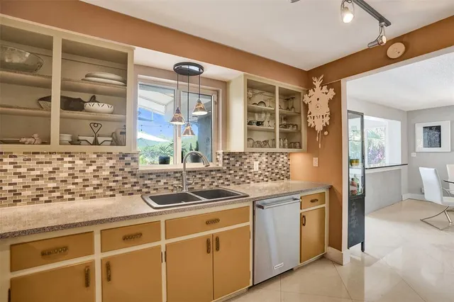 a kitchen with stainless steel appliances granite countertop a stove and a sink