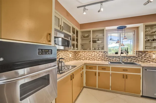 a kitchen with stainless steel appliances granite countertop a stove and a sink