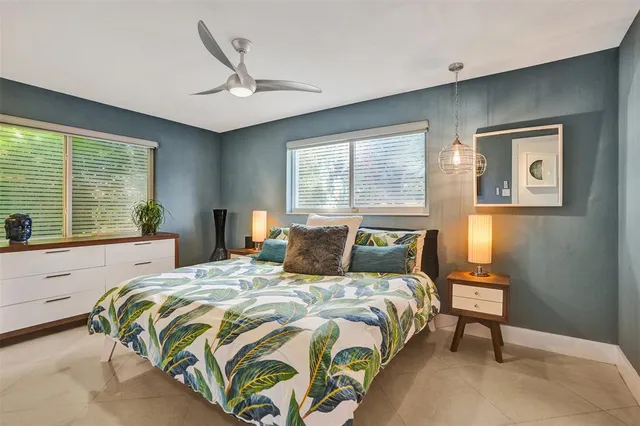 a bedroom with a bed and a large window