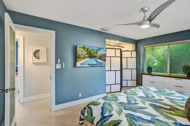 a bedroom with a bed and a window