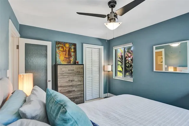 a bedroom with a bed and ceiling fan