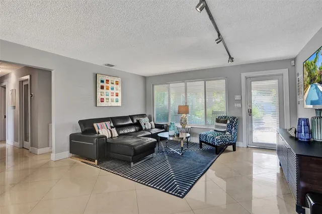 a living room with furniture or couch and a large window