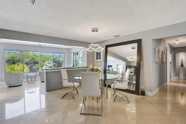 a dining room with furniture and a large window