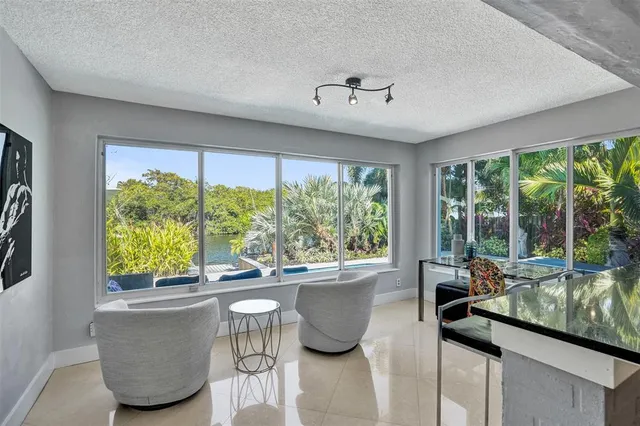 a dining room with table chairs and chandelier