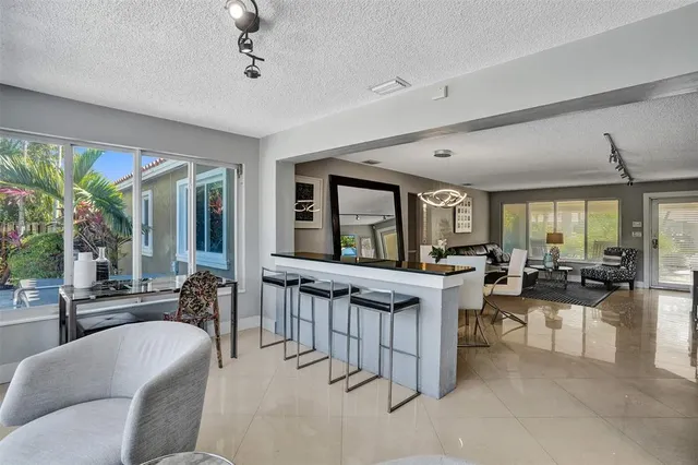 a view of a living room and kitchen area