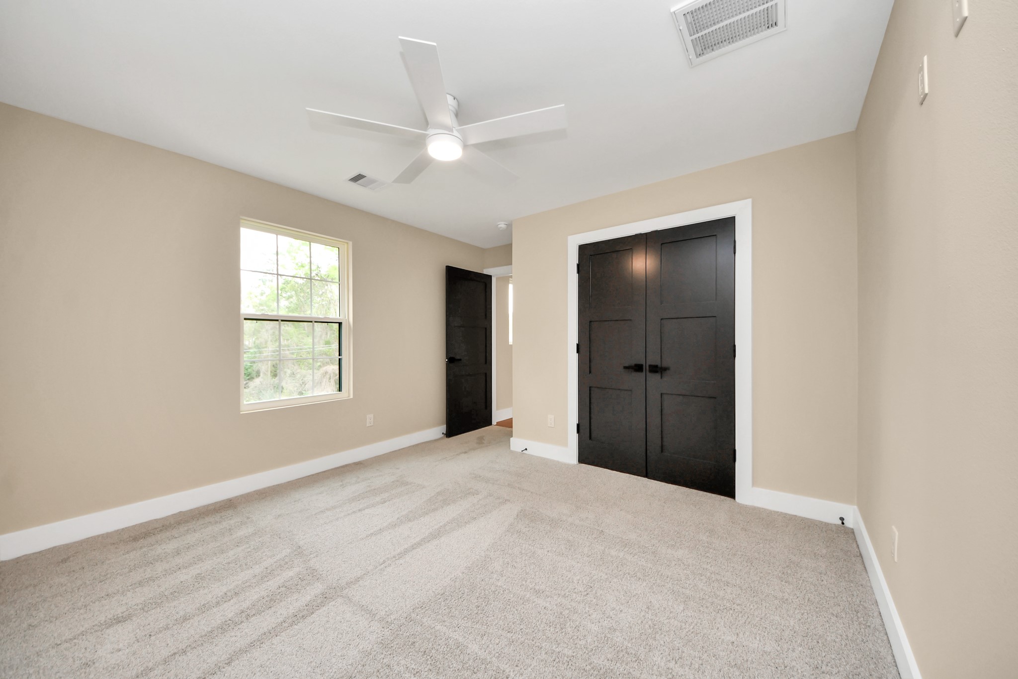 29727 Spring Forest Drive Spring, TX 77386 - Photo 27 of 37 Bedroom 3. Spacious secondary bedrooms featuring soft carpet, large windows that provide abundant natural light, and ample closet space.