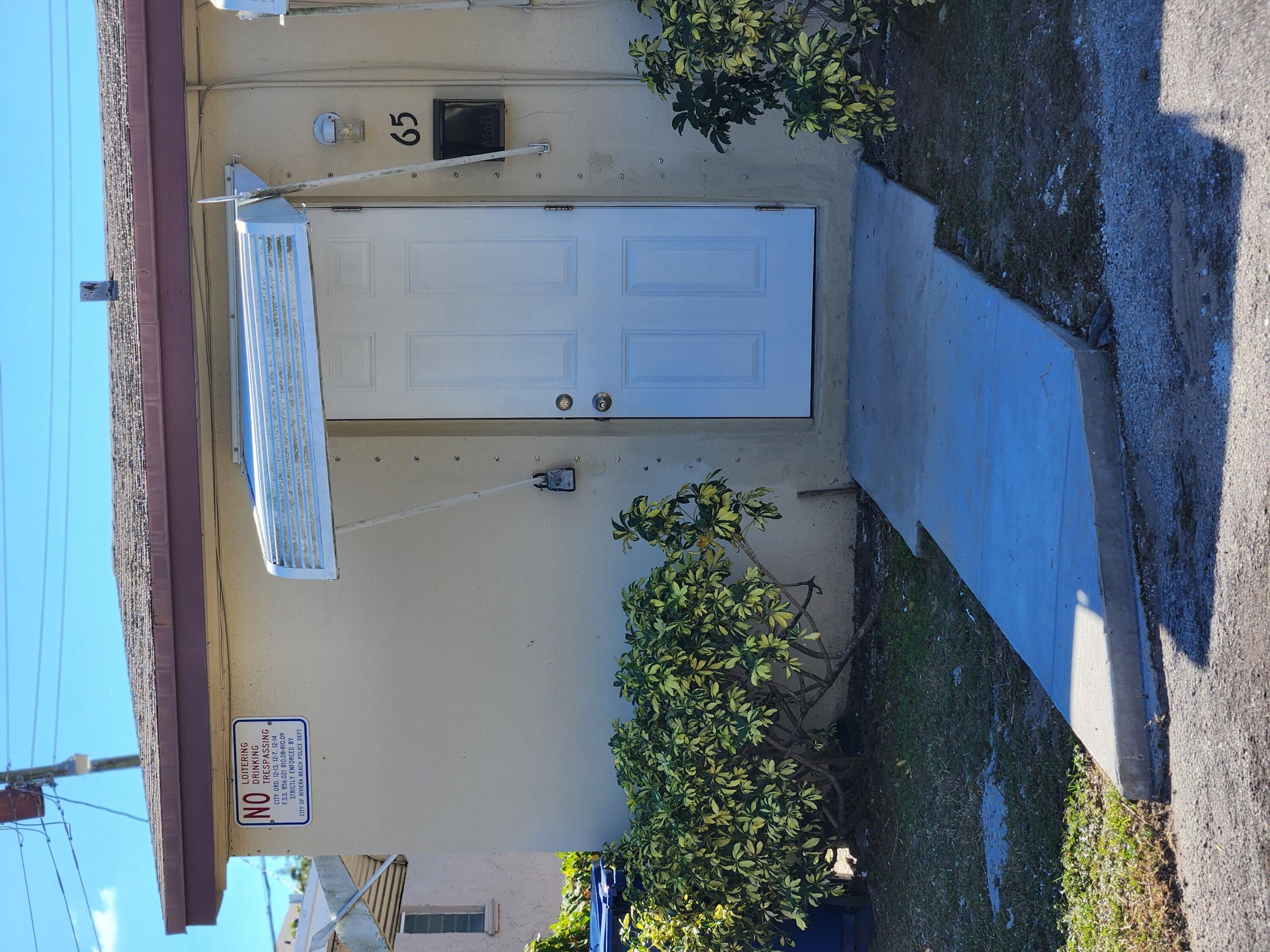 65 West 34th Street, Unit A Riviera Beach, FL 33404 - Photo 1 of 17 a view of front door and deck of house