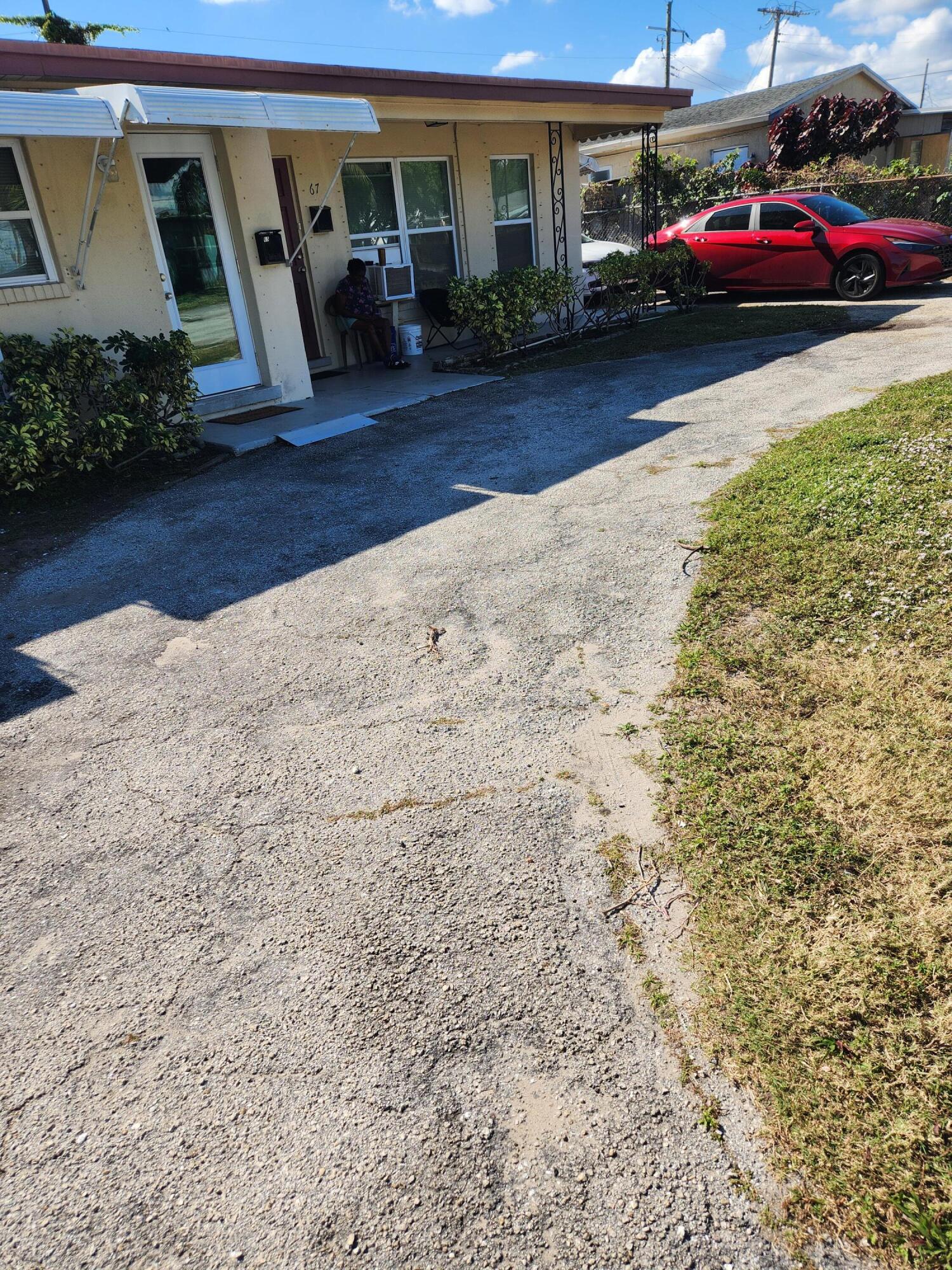 65 West 34th Street, Unit A Riviera Beach, FL 33404 - Photo 14 of 17 a view of a car parked in front of a house