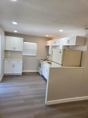 a view of a kitchen with wooden floor