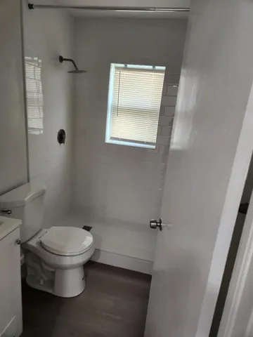a white toilet sitting next to a bathroom sink