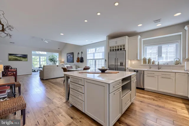 a kitchen with stainless steel appliances a sink stove refrigerator and cabinets